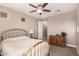 Simple bedroom with ceiling fan and brass bed frame at 13524 W Sierra Vista Dr, Glendale, AZ 85307