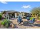 Spacious patio with fire pit, seating, and lush green lawn at 17910 E Cindercone Rd, Rio Verde, AZ 85263