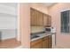 Small kitchenette with wood cabinets, microwave, and mini-fridge at 17937 W Weatherby Dr, Surprise, AZ 85374