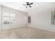 Well-lit bedroom with tile flooring and plantation shutters at 17937 W Weatherby Dr, Surprise, AZ 85374
