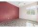 Bedroom with terracotta wall, tile floor, and window shutters at 17937 W Weatherby Dr, Surprise, AZ 85374