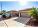 Front view of house with two-car garage and gated courtyard entry at 17937 W Weatherby Dr, Surprise, AZ 85374