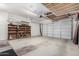 Garage with overhead storage and shelving at 17937 W Weatherby Dr, Surprise, AZ 85374