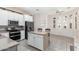 Eat-in kitchen with island, stainless steel appliances, and white cabinets at 17937 W Weatherby Dr, Surprise, AZ 85374