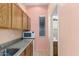 Small kitchenette with microwave, sink, and cabinets at 17937 W Weatherby Dr, Surprise, AZ 85374
