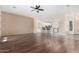 Open concept living room with hardwood floors and kitchen view at 17937 W Weatherby Dr, Surprise, AZ 85374