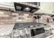 Stainless steel gas cooktop with modern controls and a stylish hood at 1823 N Atwood --, Mesa, AZ 85207