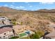 Aerial view of two-story house with pool, desert landscape, and mountain views at 2305 W Long Shadow Trl, Phoenix, AZ 85085