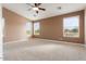 Spacious bedroom with neutral walls, ceiling fan, and large windows at 2305 W Long Shadow Trl, Phoenix, AZ 85085