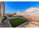 Landscaped backyard featuring a patio, fire pit, and artificial turf at 24748 W Jessica Ln, Buckeye, AZ 85326