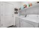 Laundry room with washer, dryer and shelving at 24748 W Jessica Ln, Buckeye, AZ 85326