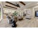 Open concept living room with hardwood floors, exposed beams, and views to the kitchen at 2532 N Williams St, Mesa, AZ 85203