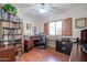 Home office with built-in shelving, a large desk, and hardwood floors at 27174 N 85Th Dr, Peoria, AZ 85383