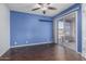 Bedroom with blue wall, wood floors and sliding door to patio at 310 W Pontiac Dr # 3, Phoenix, AZ 85027