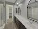 Elegant bathroom with double sinks, large mirrors, and a walk-in shower at 3576 N Carlton St, Buckeye, AZ 85396