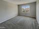 Well-lit bedroom with carpeted floors and a window at 3576 N Carlton St, Buckeye, AZ 85396