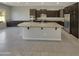 Modern kitchen with dark cabinetry and large island at 3576 N Carlton St, Buckeye, AZ 85396