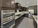 Modern kitchen with stainless steel appliances and dark wood cabinets at 3576 N Carlton St, Buckeye, AZ 85396