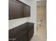 Laundry room with dark brown cabinets and a toilet at 3576 N Carlton St, Buckeye, AZ 85396