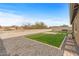 Artificial turf and gravel backyard with a block wall at 442 W Black Hawk Pl, Casa Grande, AZ 85122