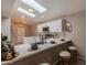 Modern kitchen island with seating and skylights at 4713 N Brookview Ter, Litchfield Park, AZ 85340