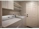 Laundry room with washer, dryer, and ample shelving at 4713 N Brookview Ter, Litchfield Park, AZ 85340