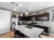 Modern kitchen with dark cabinetry, granite countertops, and island at 803 W Fairlane Ct, Casa Grande, AZ 85122