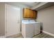 Laundry room with washer, dryer, and upper cabinets at 9455 W Behrend Dr, Peoria, AZ 85382