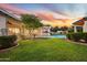 Spacious backyard with a pool, lush grass, and gazebo at 115 S Galaxy Dr, Chandler, AZ 85226