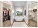 Luxurious bathroom featuring a freestanding soaking tub and walk-in closets at 115 S Galaxy Dr, Chandler, AZ 85226