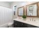 Elegant bathroom boasts dual sinks, a large mirror, and a shower/tub combo at 115 S Galaxy Dr, Chandler, AZ 85226