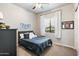 Cozy bedroom with striped bedding and ample natural light at 115 S Galaxy Dr, Chandler, AZ 85226