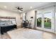 Bright bedroom with a bunk bed, workspace, and French doors at 115 S Galaxy Dr, Chandler, AZ 85226