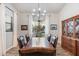 Formal dining room with a wooden table, leather chairs, and a china cabinet at 115 S Galaxy Dr, Chandler, AZ 85226