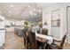Bright dining area adjacent to the kitchen with a wooden table and leather chairs at 115 S Galaxy Dr, Chandler, AZ 85226