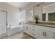 Bathroom with double vanity, soaking tub, and walk-in shower at 13014 W Campbell Ave, Litchfield Park, AZ 85340