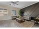 Living area with gray sofas, coffee table, and geometric wall paneling at 13014 W Campbell Ave, Litchfield Park, AZ 85340