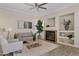 Living room with fireplace, neutral colored couch and chairs at 13014 W Campbell Ave, Litchfield Park, AZ 85340