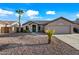 House exterior with desert landscaping and two-car garage at 13253 W Paradise Ln, Surprise, AZ 85374