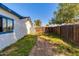 Backyard with wooden fence and grassy area at 14410 N 42Nd Pl, Phoenix, AZ 85032