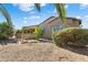 Landscaped backyard with a rock pathway and small bridge at 16938 W Desert Rose Ln, Surprise, AZ 85387