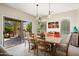 Bright dining room with wooden table and access to the patio at 16938 W Desert Rose Ln, Surprise, AZ 85387