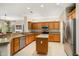 Island kitchen with granite countertops and wood cabinets at 16938 W Desert Rose Ln, Surprise, AZ 85387