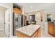 Stainless steel refrigerator and granite countertops in kitchen at 16938 W Desert Rose Ln, Surprise, AZ 85387