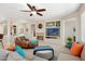 Open living room with a cozy fireplace and ample seating at 16938 W Desert Rose Ln, Surprise, AZ 85387