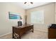 Home office with wooden desk and large window at 16938 W Desert Rose Ln, Surprise, AZ 85387