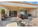 Spacious covered patio with lounge chairs and dining table at 16938 W Desert Rose Ln, Surprise, AZ 85387