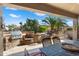 Covered patio with dining table and comfortable seating at 16938 W Desert Rose Ln, Surprise, AZ 85387
