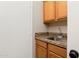 Small wet bar with granite countertop and sink at 16938 W Desert Rose Ln, Surprise, AZ 85387