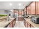 Modern kitchen featuring stainless steel appliances and granite countertops at 18348 W Hatcher Rd, Waddell, AZ 85355